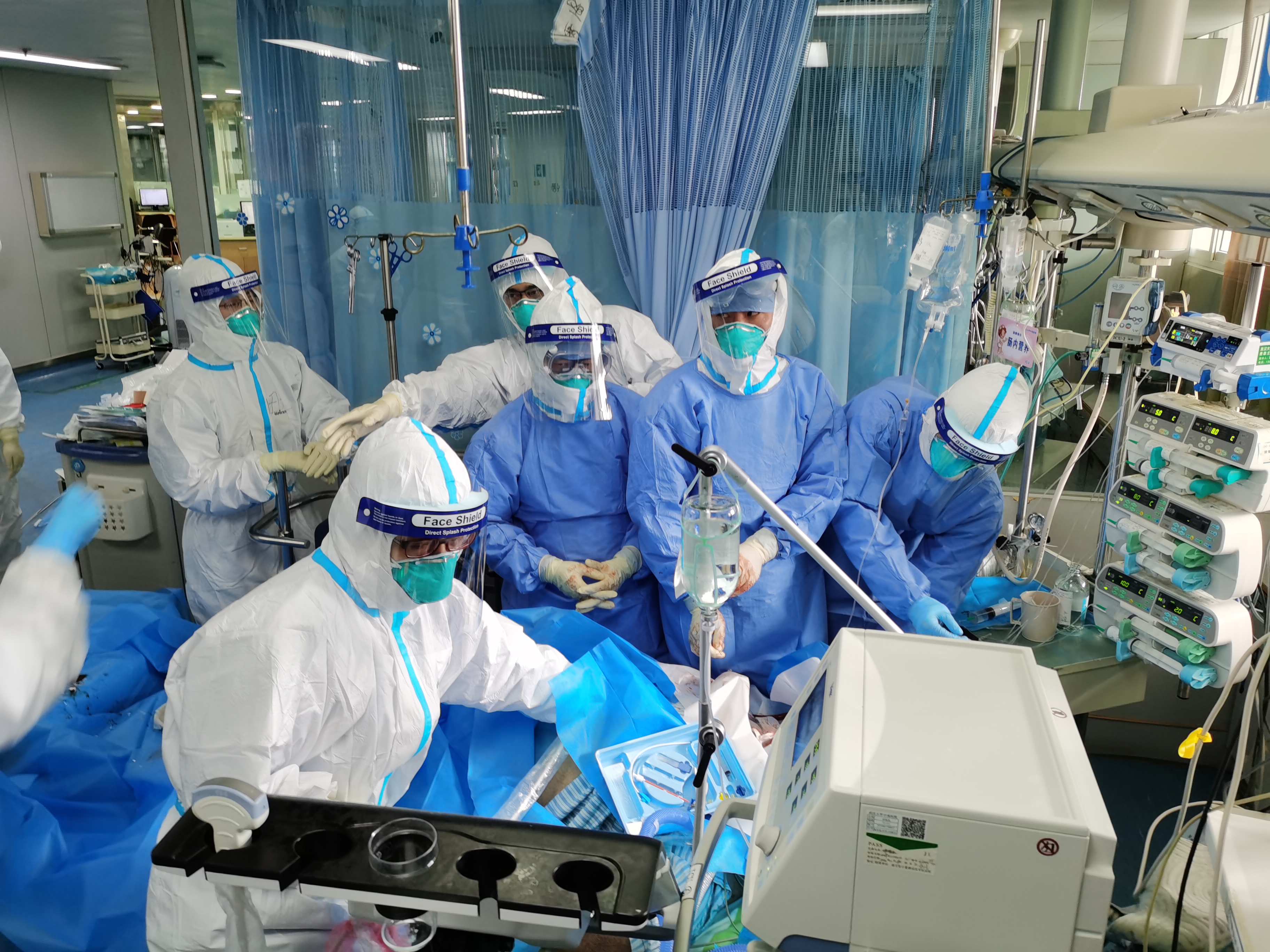 在武汉大学中南医院重症医学科隔离病房,医护人员正在为一位新冠肺炎
